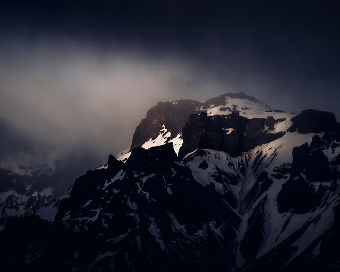Dramatic scene with snowy mountain in Iceland - edited with Dark and Dramatic Lightroom Presets