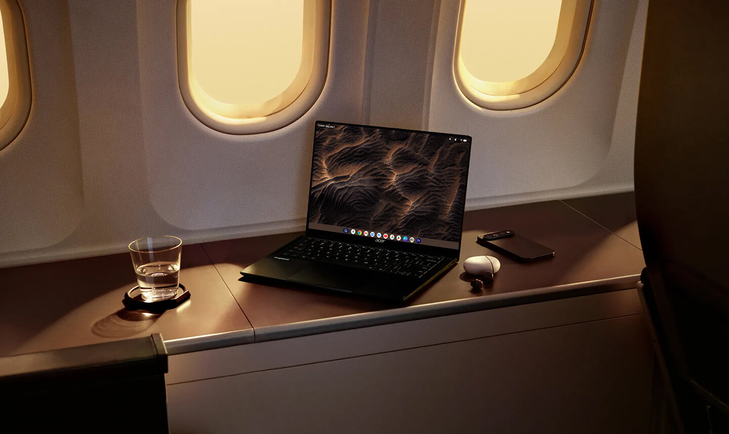 Googlebook laptop with Sand Currents wallpaper in an airplane.