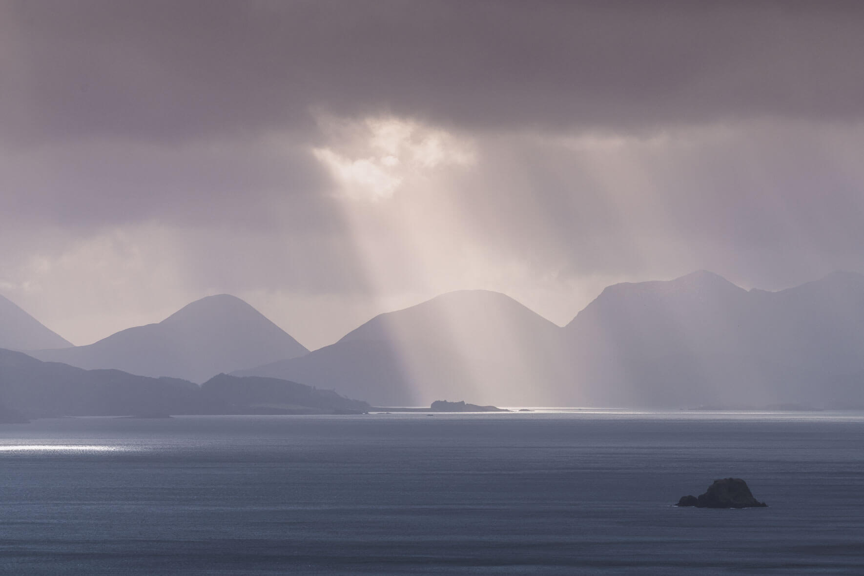 Sunbeams over small islands on the Isle of Skye