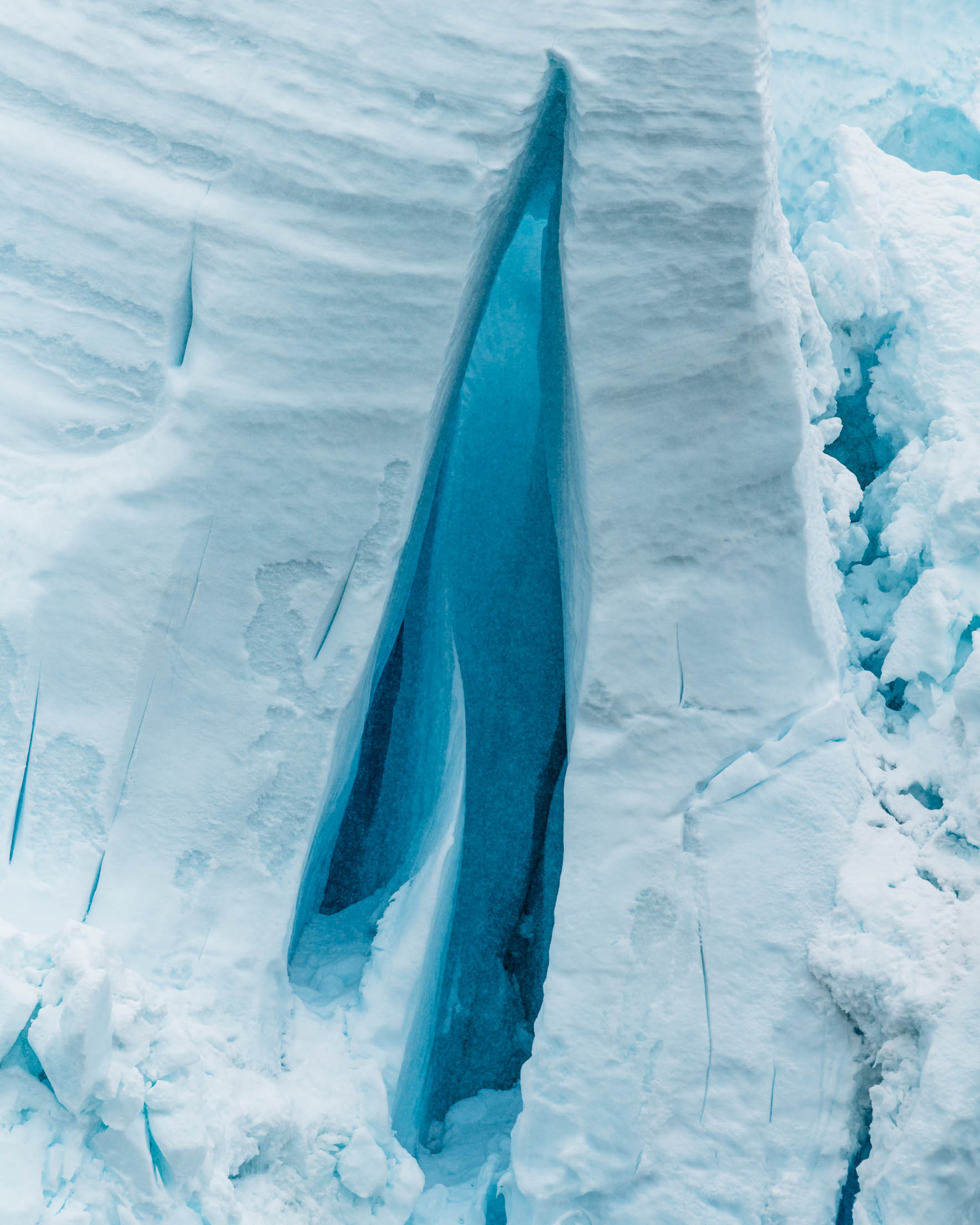 Blue glow inside a glacier crevasse of Antarctica