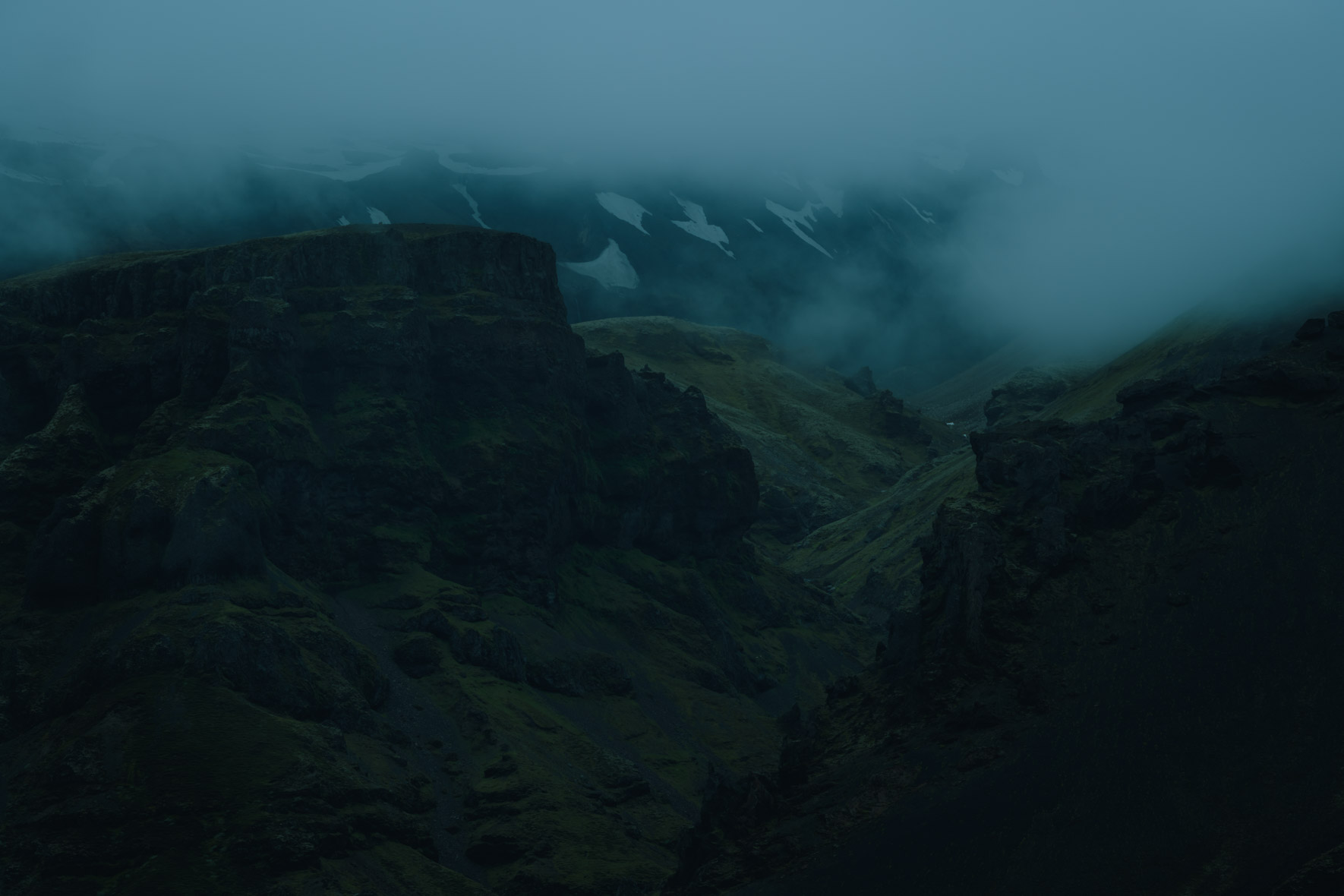 Dark and Moody Landscape in Iceland with Snowy Mountains