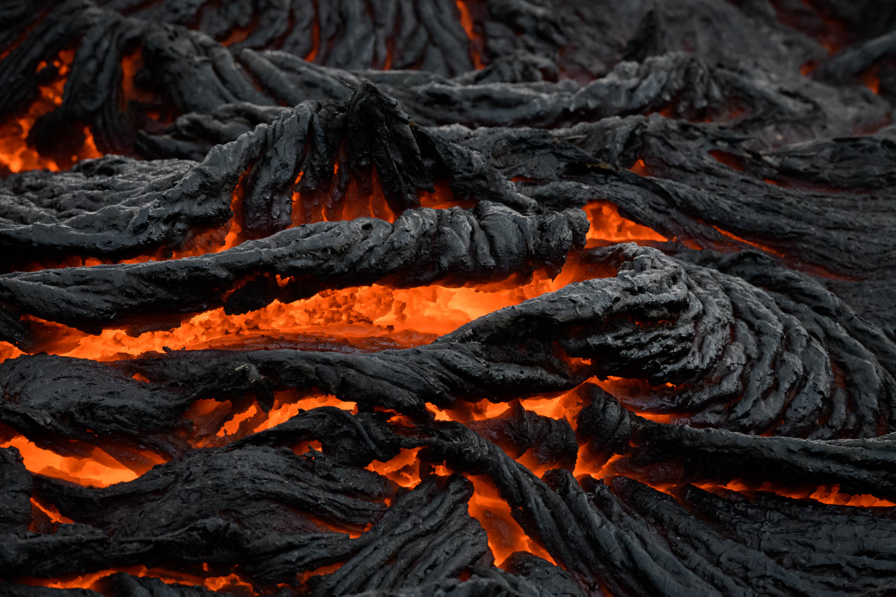 Molten lava flowing from volcanic eruption at Fagradalsfjall in Iceland