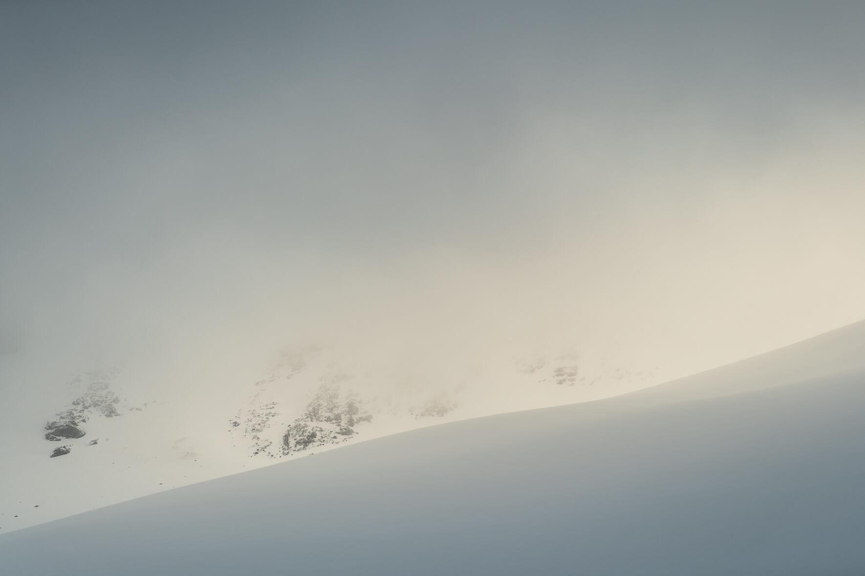 Soft light with the sun breaking through the clouds over the Sognefjellet mountains