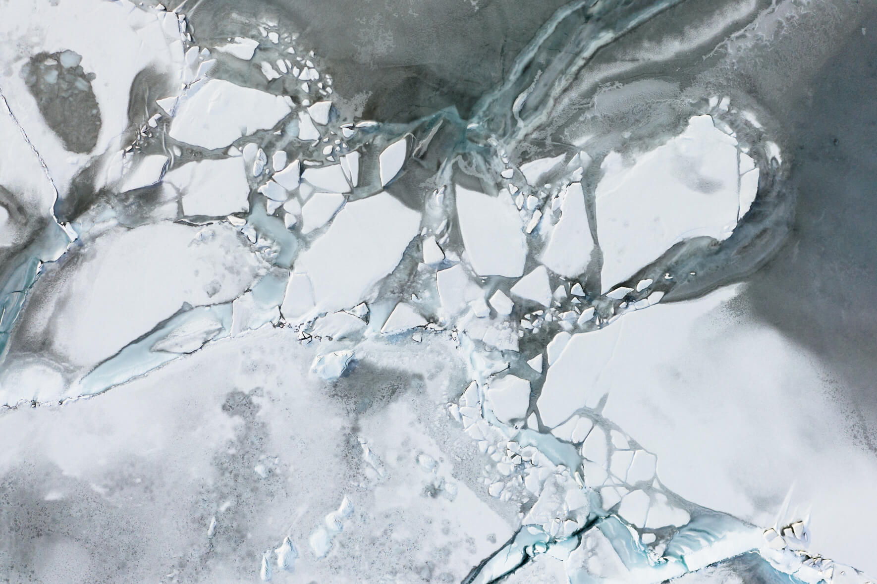 Aerial view of frozen glacier lagoon Jökulsárlón in Iceland with ice floes and snow