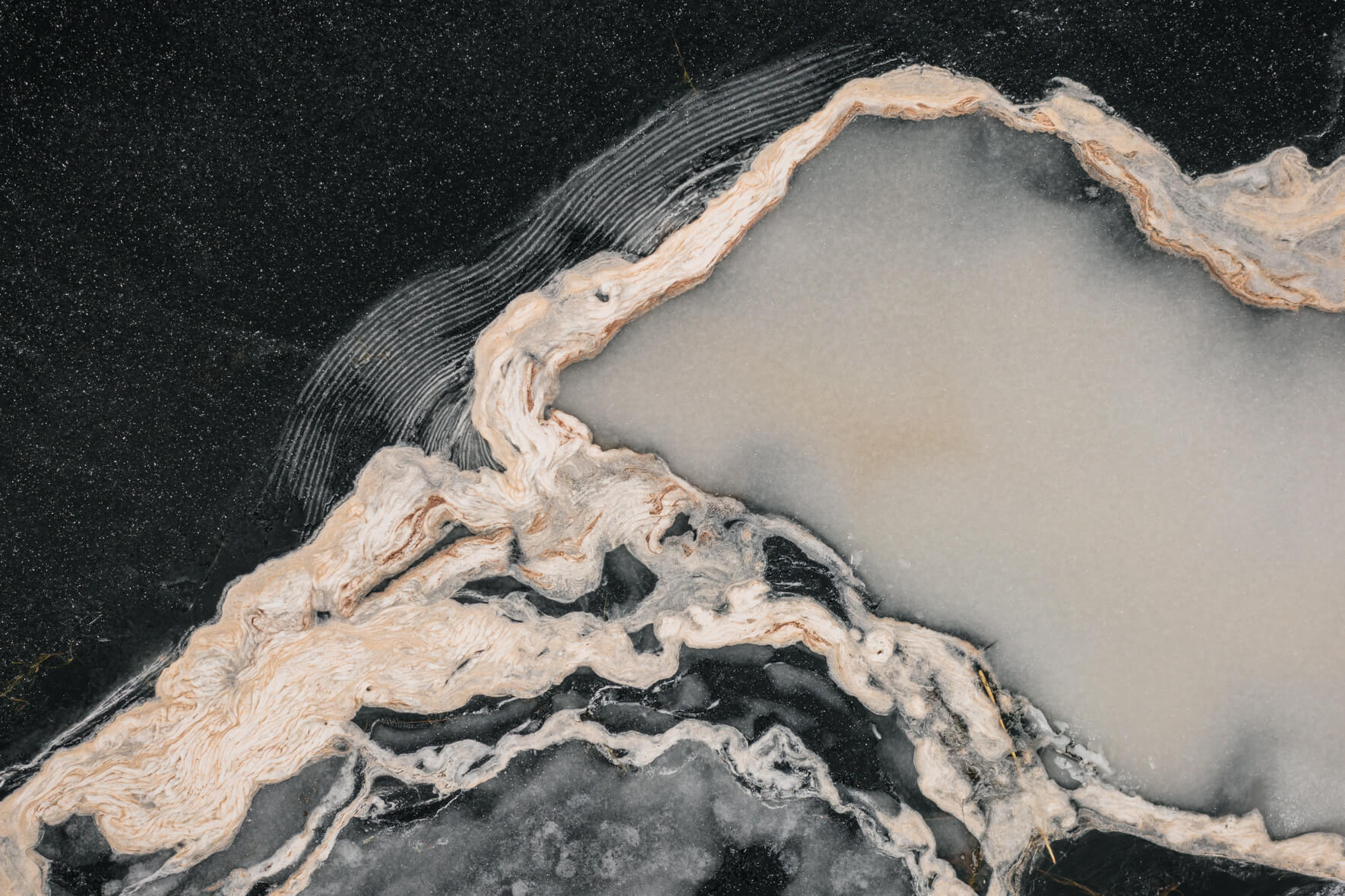 Abstract textures and patterns on the ice surface of a frozen lake in South Norway