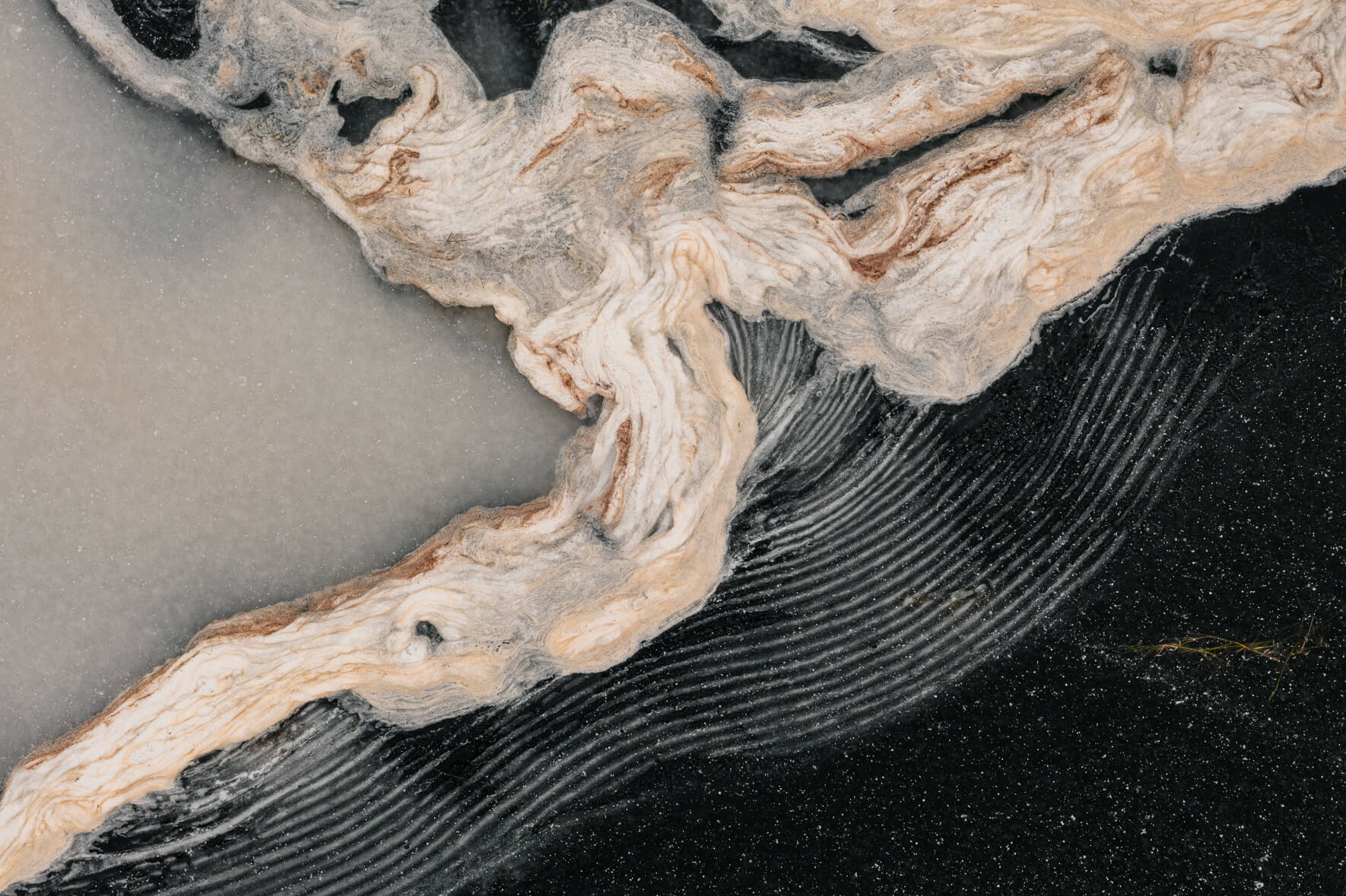 Abstract textures on the ice surface of a frozen lake in Norway