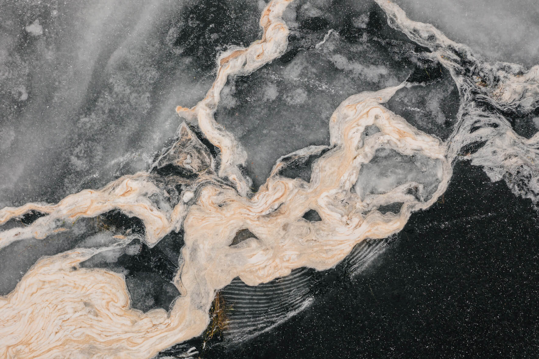 Aerial view of a frozen lake in Norway with abstract textures and patterns on the surface