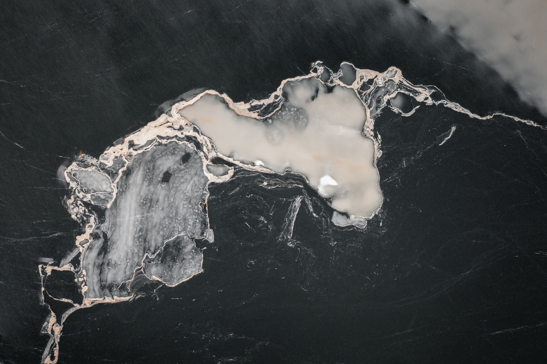 Aerial photography of a frozen lake in Norway with abstract patterns on the ice surface