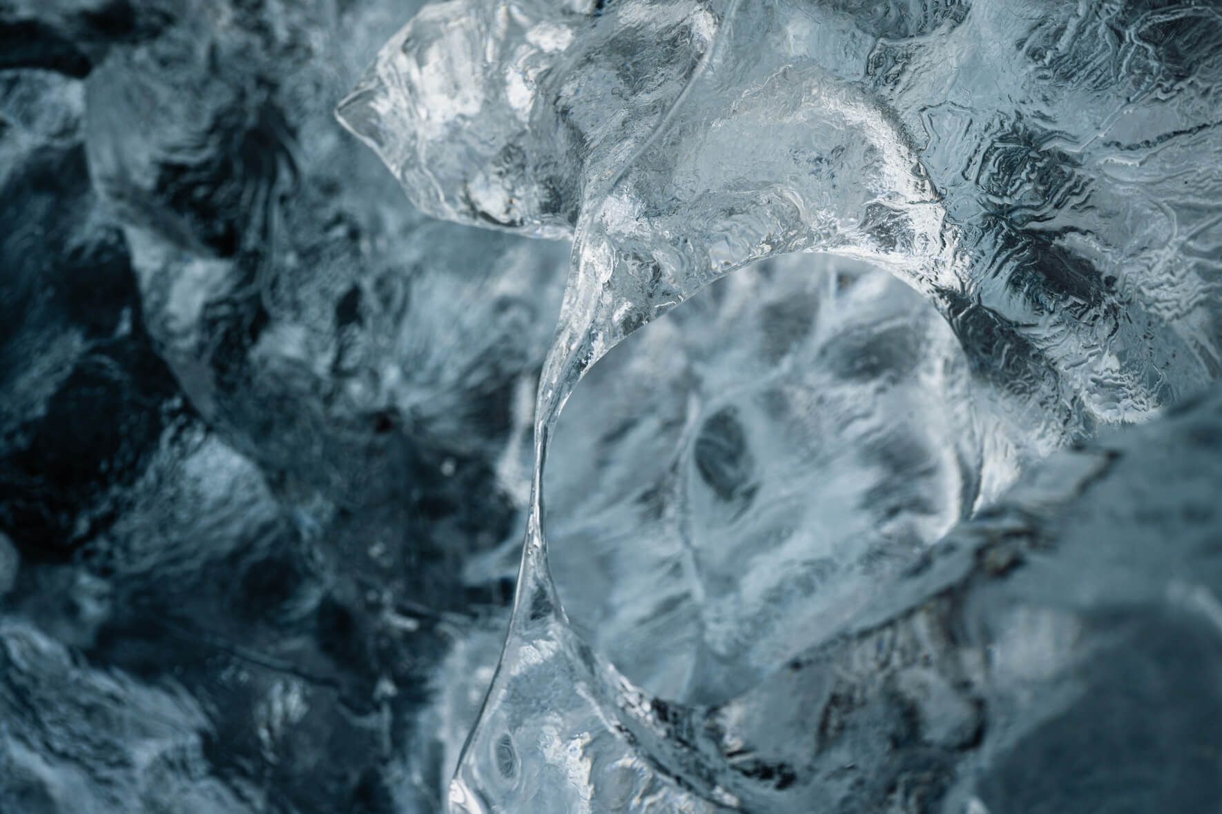 Macro view of glacial ice on black sand beach capturing fragile details