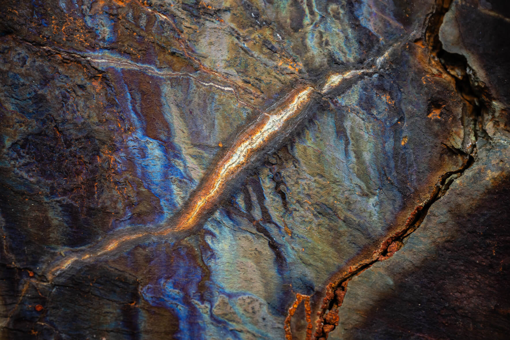 Detailed rock surface with folded layers and subtle gray and brown mineral tones