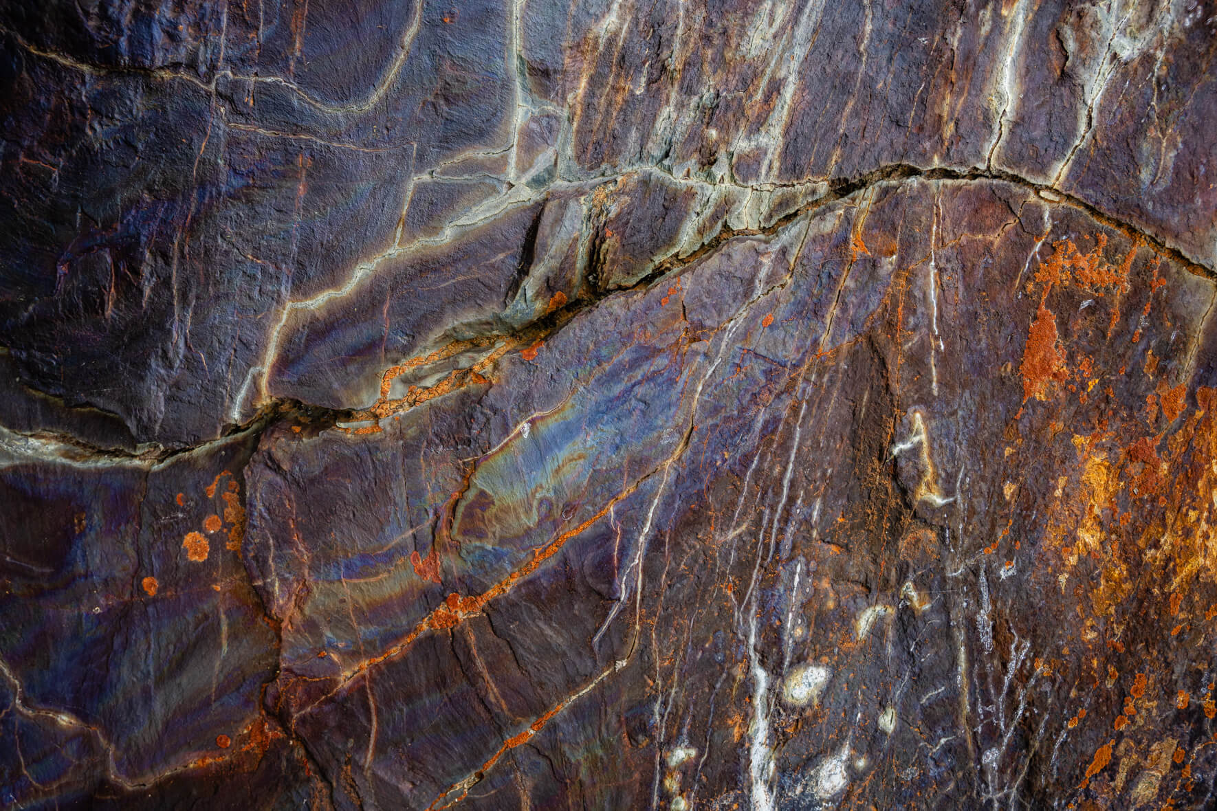 Fractured stone with white mineral veins and fine sediment traces in Norway