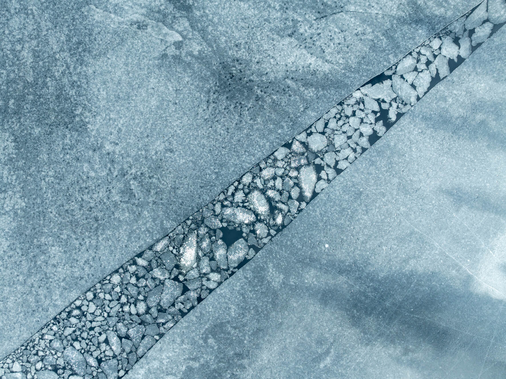 Winter composition of cracked ice and small ice floes from above