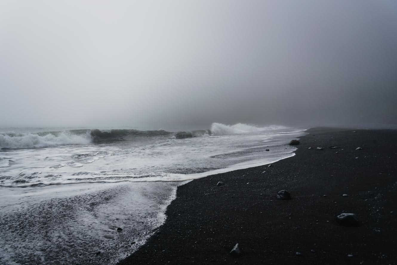 Foggy weather over black sand beach of Vik in Iceland