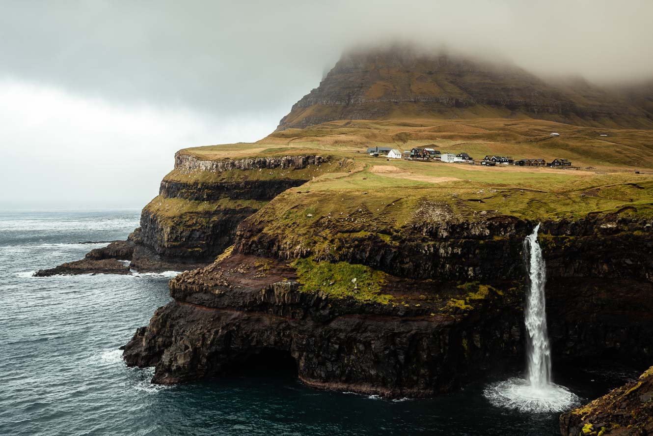 Múlafossur Waterfall on the Faroe Islands with huge cliffs