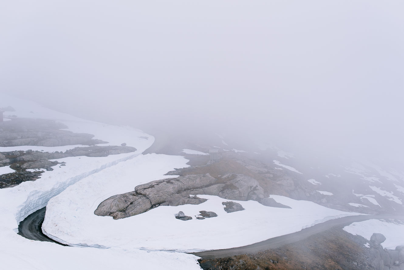 Moody landscape with winding mountain road in snow