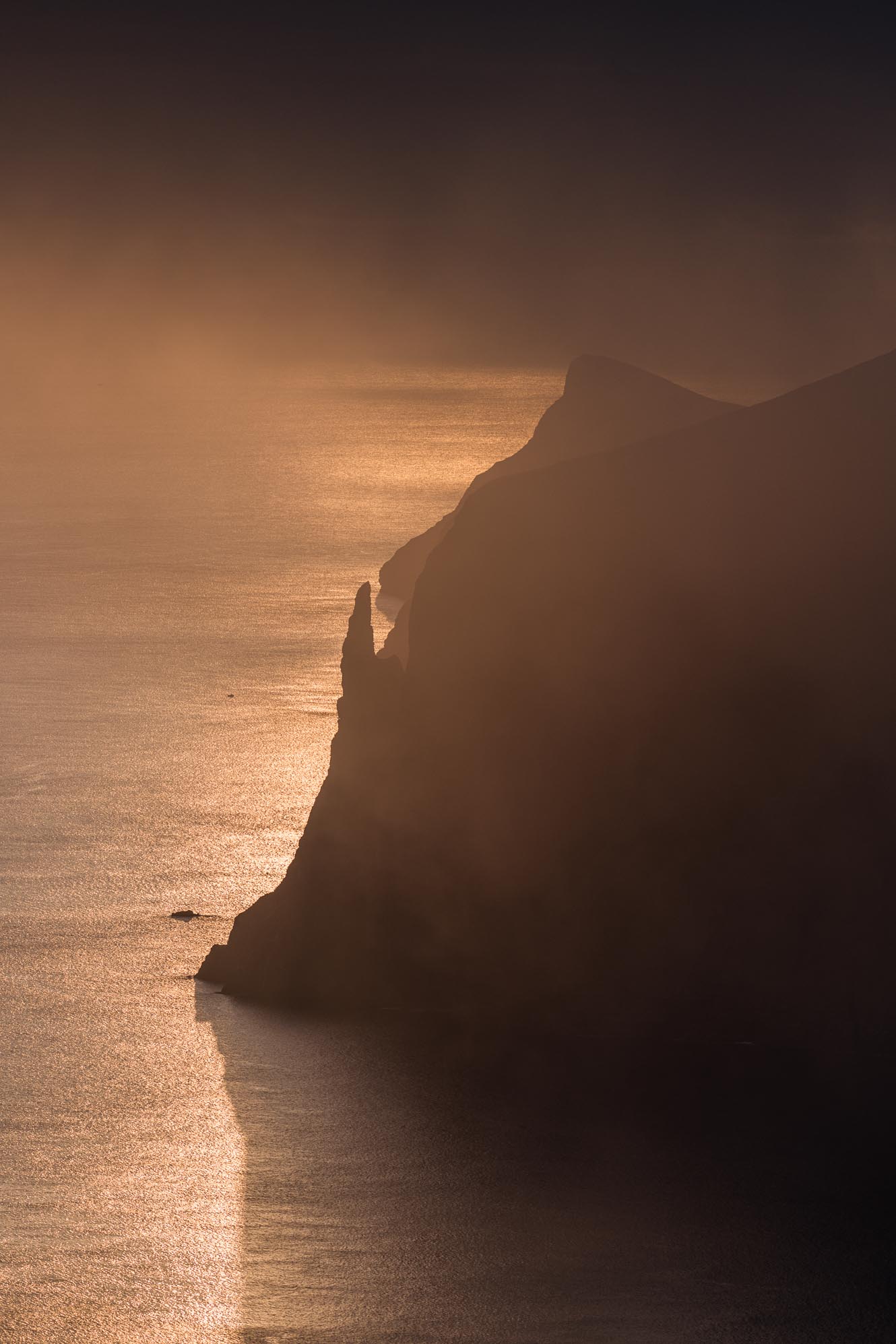 Golden sunset over the Faroe Islands with dark clouds