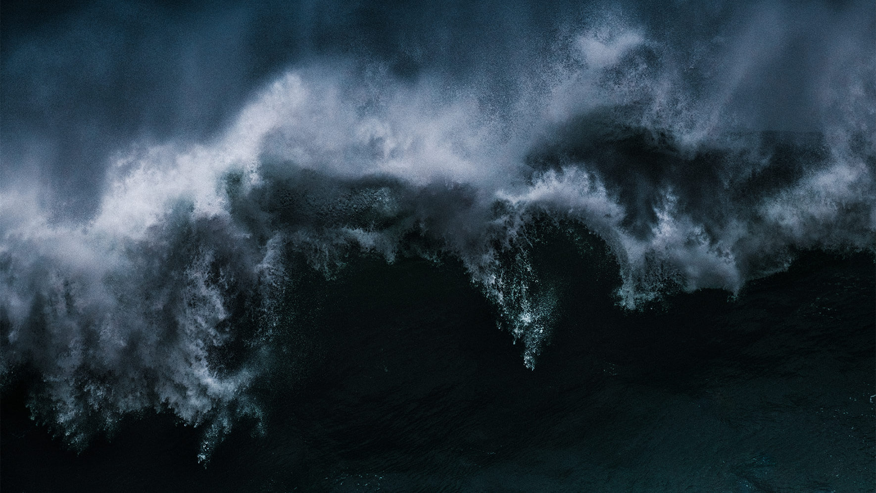 Crashing waves on NazarΓ© beach in Portugal
