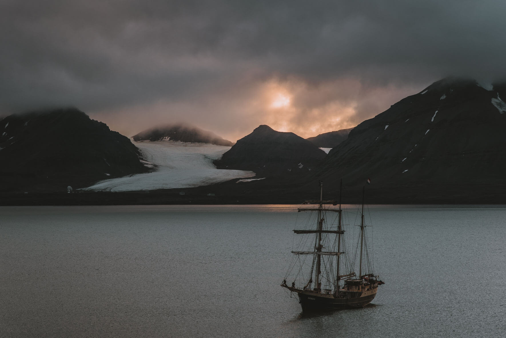 Sunset over Ny-Ã…lesund on Svalbard and the Dutch sailing ship Antigua