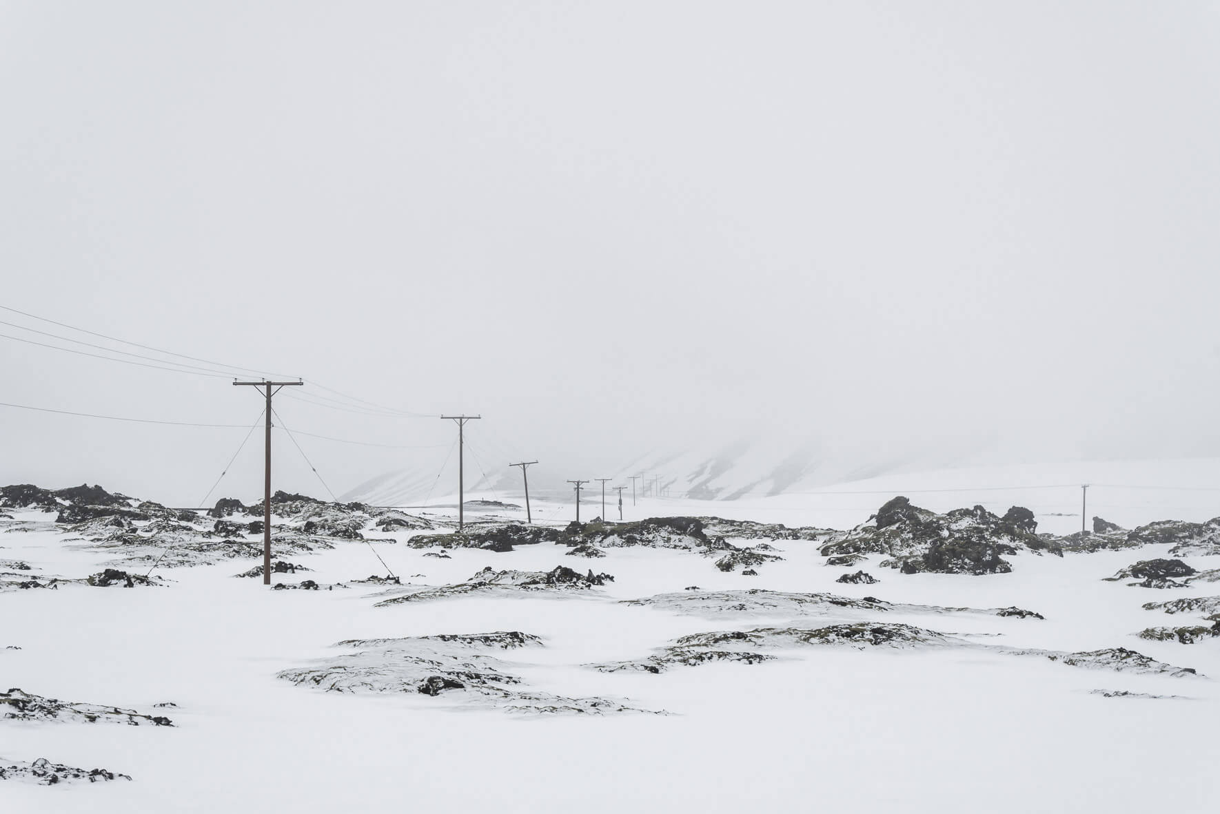 Power lines in foggy winter landscape in Iceland