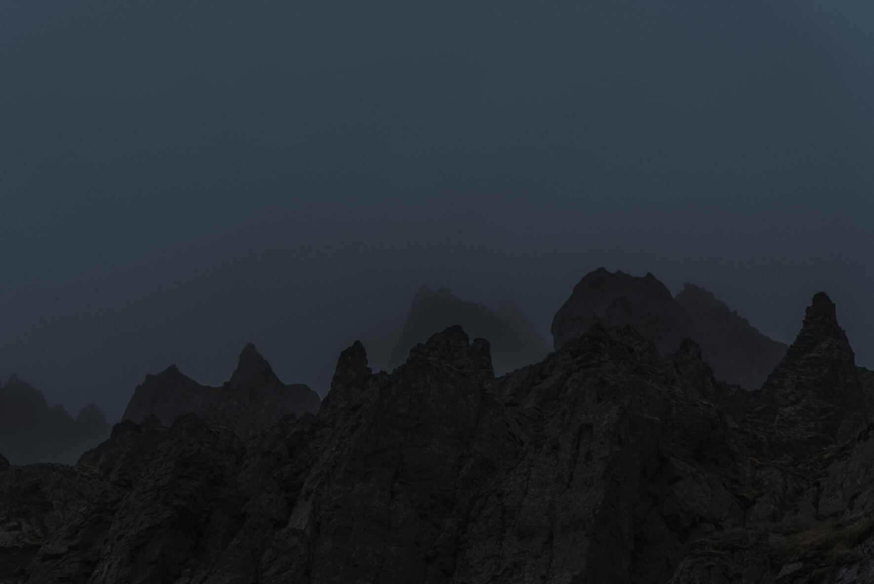 Dark silhouettes of rocks in the Westfjords of Iceland