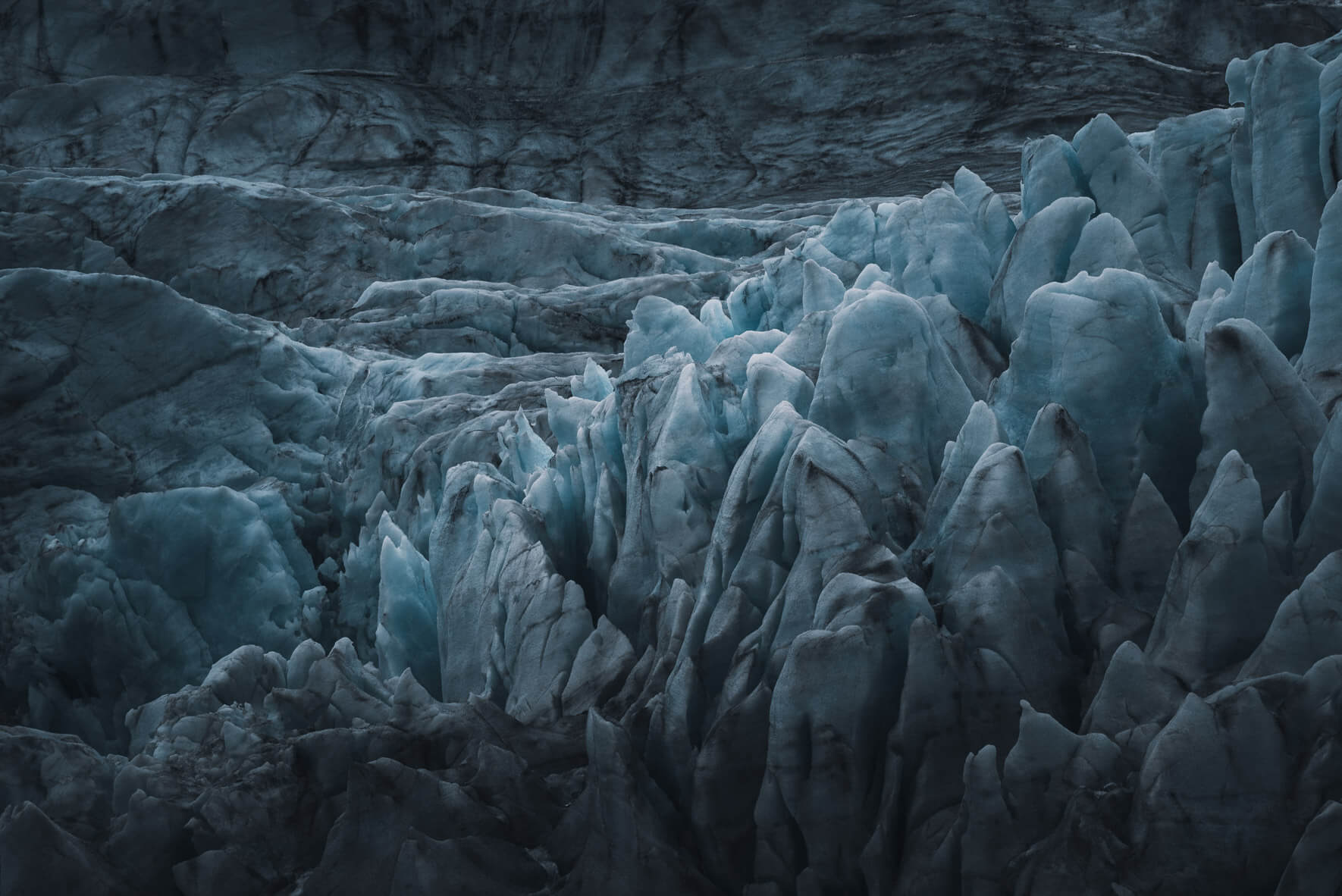 Glacier ice and dark sand on the west coast of Svalbard (Spitsbergen) in Norway
