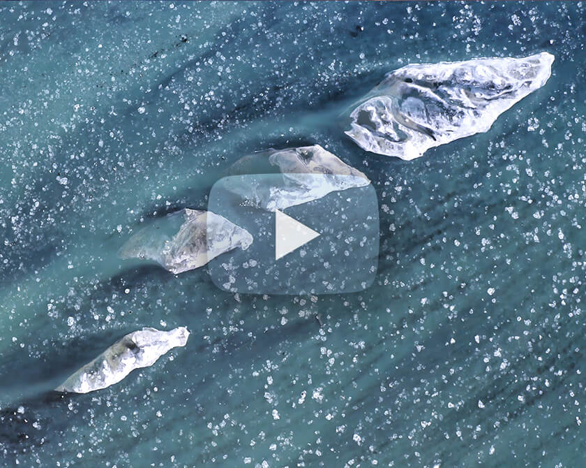 Aerial video series of a glacier river in Iceland in winter with ice floes
